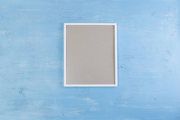 Blank photo frame on blue wood background. - Фото, зображення