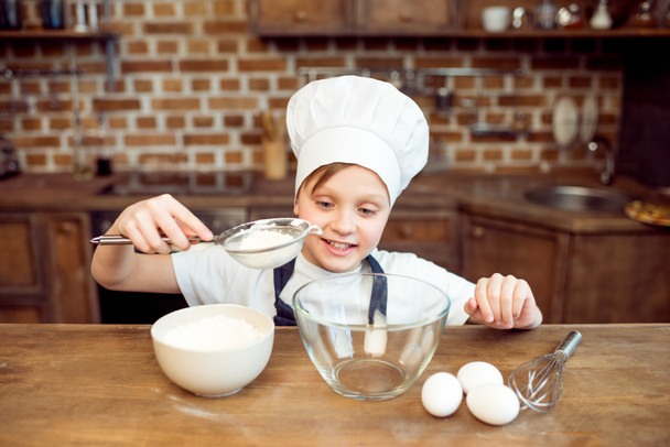 boy pouring sugar in bowl - Fotografie, Obrázek
