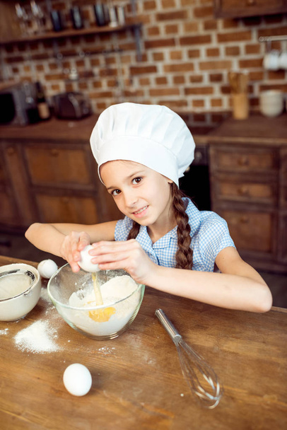 girl making dough for cookies - Foto, afbeelding