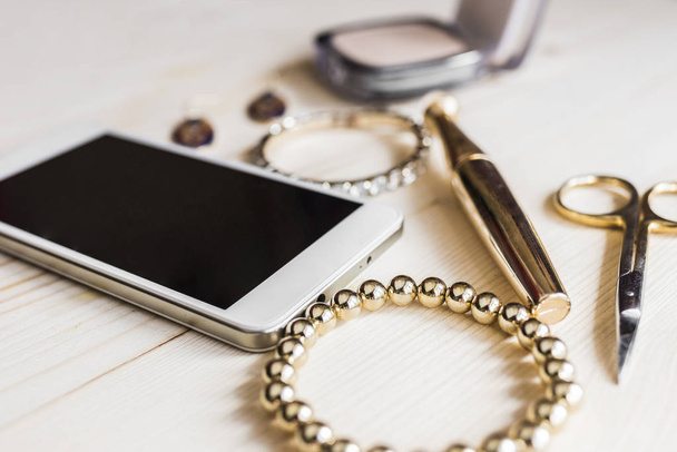 Gold jewelry, makeup and phone 2 - Photo, Image