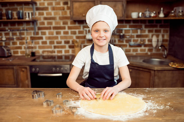 boy making shaped cookies - Fotó, kép