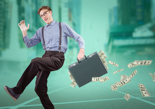 Business man on track with money falling out of briefcase - Foto, afbeelding