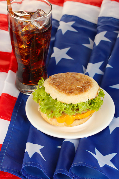 tasty sandwich and glass with cola, on american flag - Zdjęcie, obraz