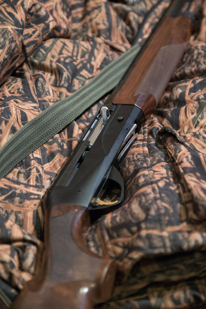 semi-automatic hunting rifle, close-up, camouflage jacket, green belt - Photo, Image