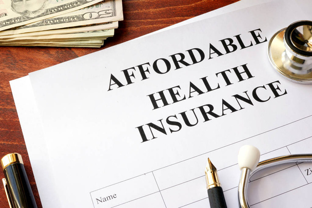 Affordable health insurance policy on a table. - Fotoğraf, Görsel