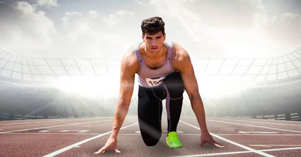 Digitally generated image of male athlete at starting point on racing track - Foto, Imagen