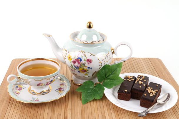 Tetera y taza de té con brownies
 - Foto, Imagen