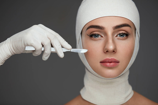 Portrait Of Beautiful Woman With Soft Skin And Head In Bandages  - 写真・画像