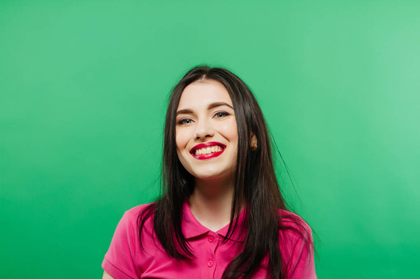 attractive smiling woman portrait on green background - Foto, Imagem