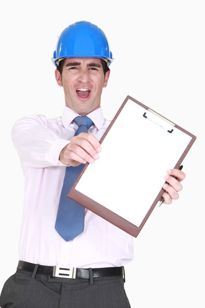 Ecstatic man in a hardhat with a blank clipboard - Fotó, kép