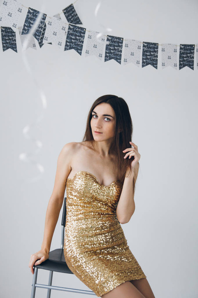 Girl in a gold dress - Фото, изображение