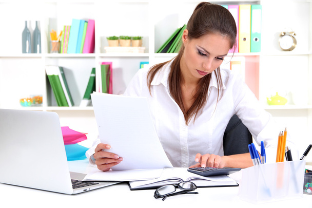 Young pretty business woman with notebook in office - Photo, image