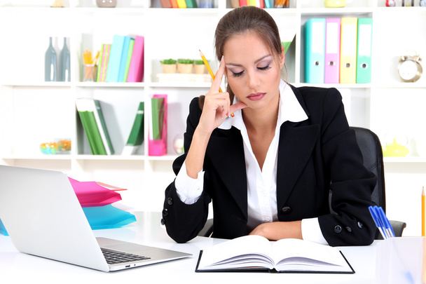 Tired business woman with documents in her workplace - Zdjęcie, obraz