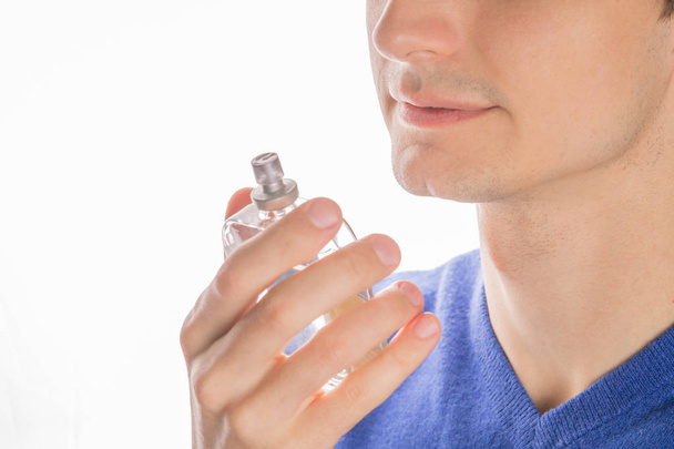 Young man smelling perfume - Foto, imagen
