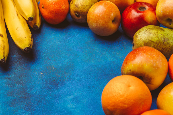 Fresh juicy fruit on a blue background - Foto, Imagen