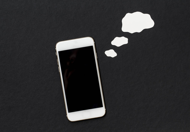 White phone with blank text cloud. Smartphone and cartoon style cloud. - Фото, изображение