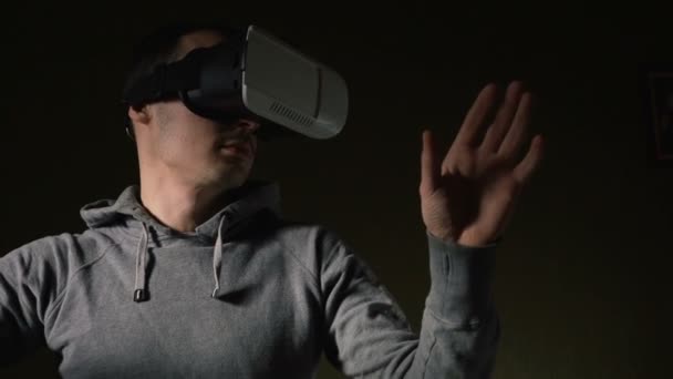 Mann trägt Virtual-Reality-Headset im Wohnzimmer. - Filmmaterial, Video