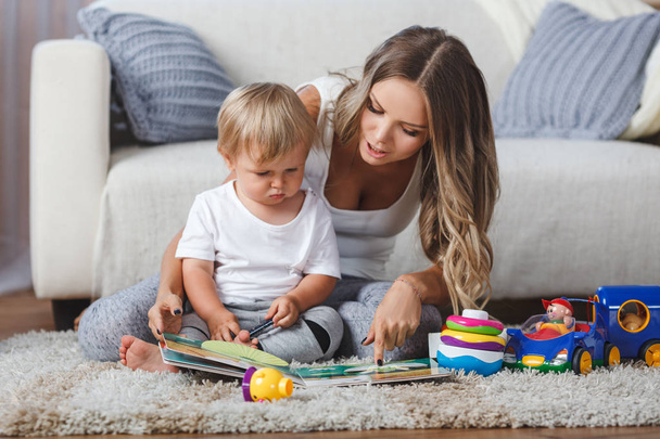 cute mother and child boy play together indoors at home - Fotoğraf, Görsel