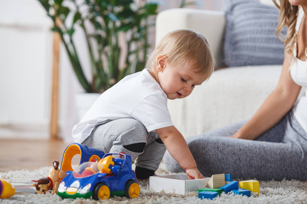 cute mother and child boy play together indoors at home - Foto, Bild