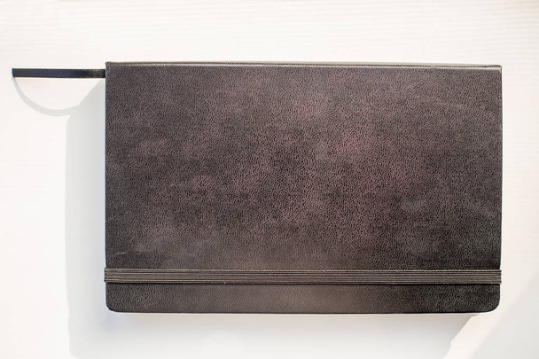 Black leather note book diary with stripee on white background - Valokuva, kuva