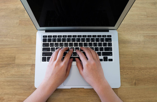 Woman office worker is typing keyboard of laptop, business or le - Fotó, kép