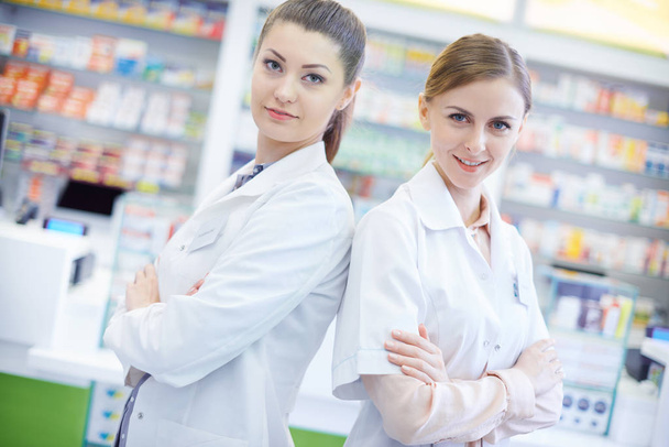 Two attractive pharmacists in pharmacy  - Valokuva, kuva