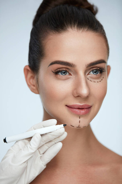 Treatment. Beautician Drawing Surgical Lines On Woman Face - Fotó, kép