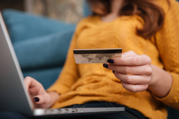 Close up of a woman buying online with bank card - Photo, Image