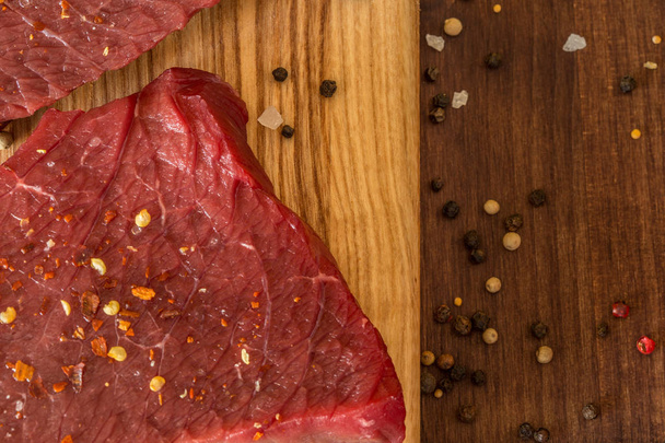 raw beef steak with ingredients for cooking - Foto, imagen