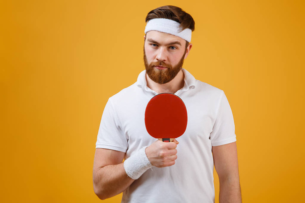 Handsome young sportsman holding racket for table tennis - Fotoğraf, Görsel