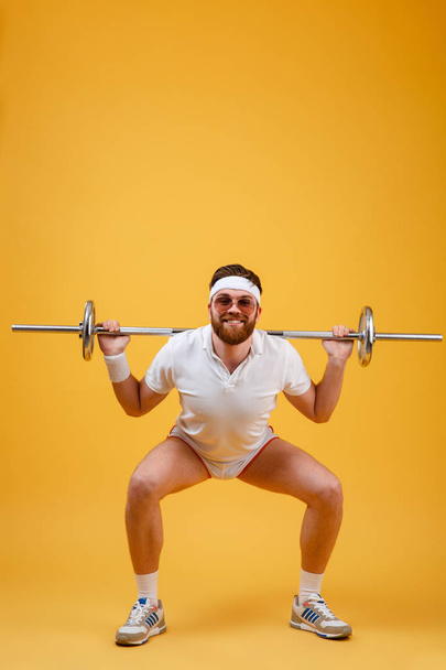 Happy young sportsman make sport exercises with barbell - Fotoğraf, Görsel