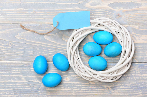 traditional eggs painted in blue color inside woven wooden wreath - Fotografie, Obrázek