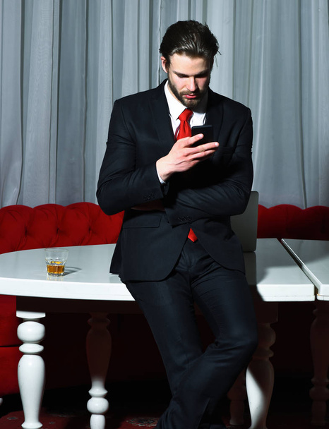 bearded man, businessman with glass of whiskey, cell phone - Photo, image