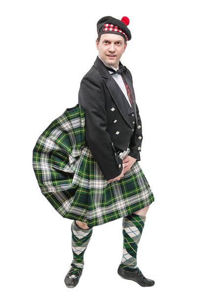 Skotlantilainen mies perinteisessä kansallispuvussa puhalluskiltin kanssa
  - Valokuva, kuva