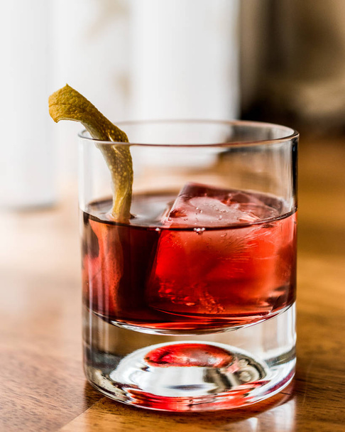 Negroni Cocktail with lemon peel and ice - Foto, imagen