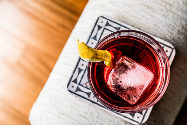 Negroni Cocktail with lemon peel and ice - Фото, изображение