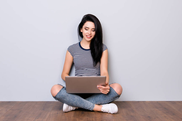 Happy young woman in casual clothes work with laptop and checkin - Фото, изображение