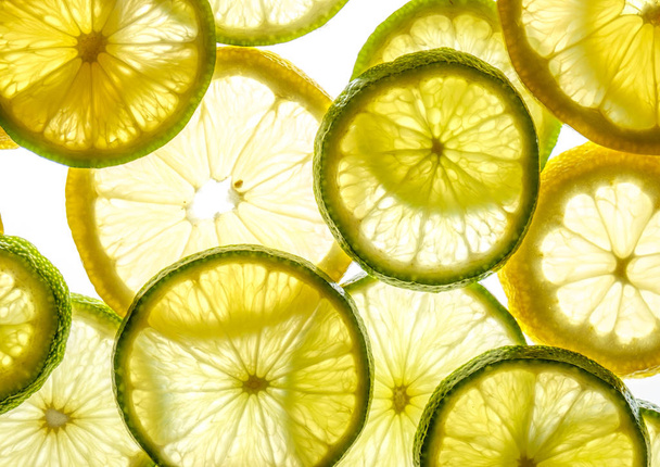 Bright citrus lime and lemon slices on white - Fotó, kép