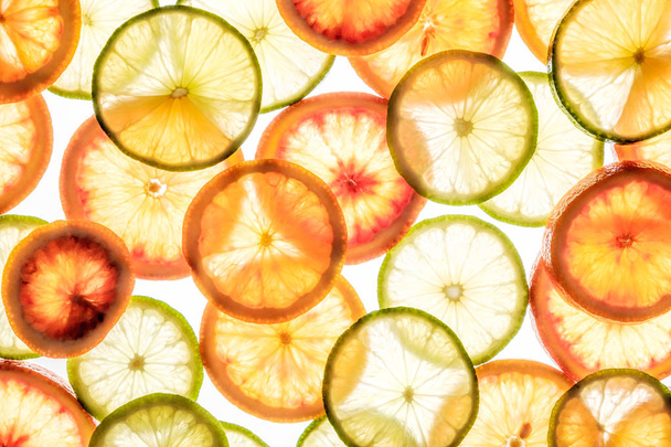 Bright lime and orange slices on white - Fotó, kép