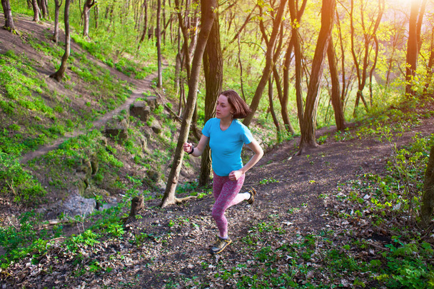 Girl running in the woods - Photo, Image