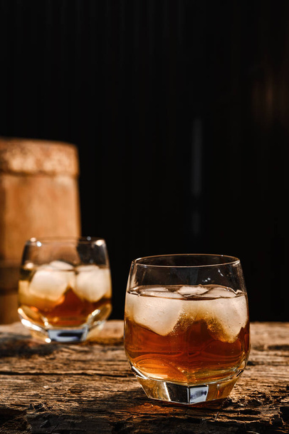Glass of whiskey on wooden background close up - Foto, immagini