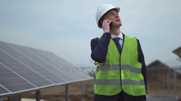 Businessman with phone near panels - Video