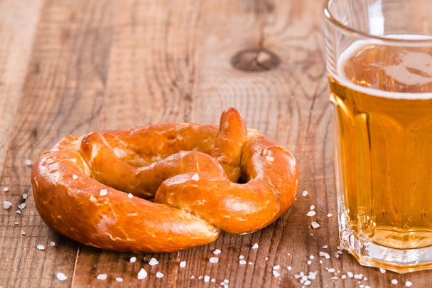 Bavarian pretzels on wooden table. - Foto, afbeelding