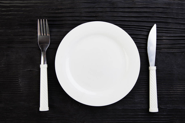 wooden  black plate fork knife top view - Фото, зображення