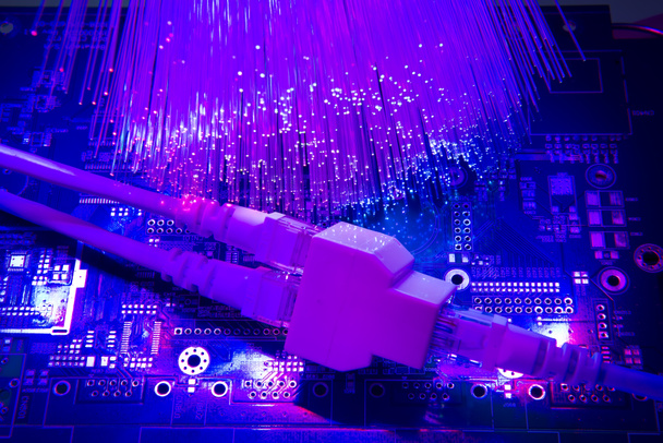 Network cables and hub closeup with fiber optical background - Photo, Image