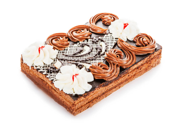 Kondensmilch und Schokoladenkuchen mit Sahneblüten verziert i - Foto, Bild