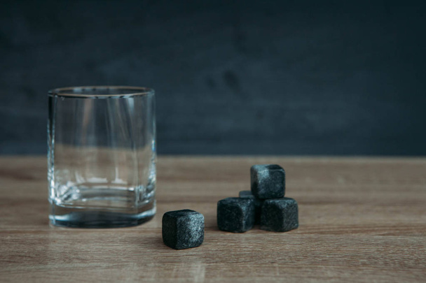 Stones for cooling whiskey and glases tumbler on dark wooden background - Foto, Imagen