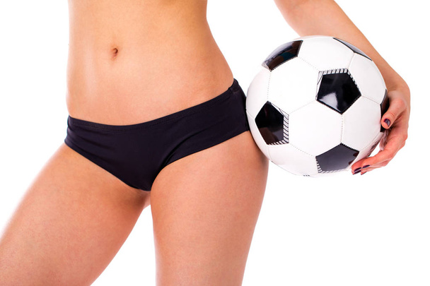 Soccer ball and feminine hips. Black Underwear. Close up photo o - Photo, image