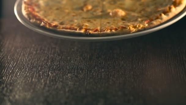 waiter puts ready tasty pizza on table. Slow Motion - Video