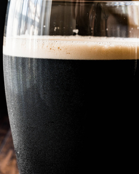 Dark Beer on wooden surface. Close up view. - Photo, image